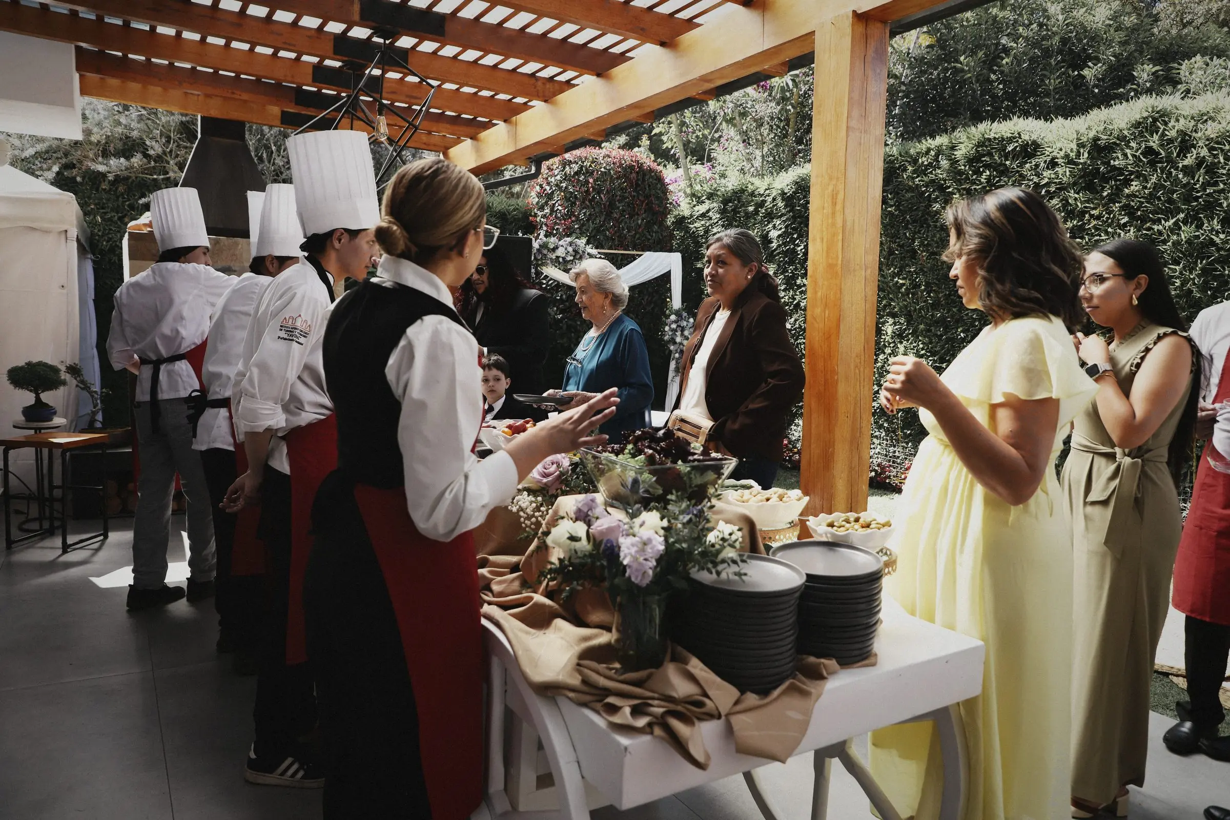 Cooks and service staff working a buffet line as guests are served.